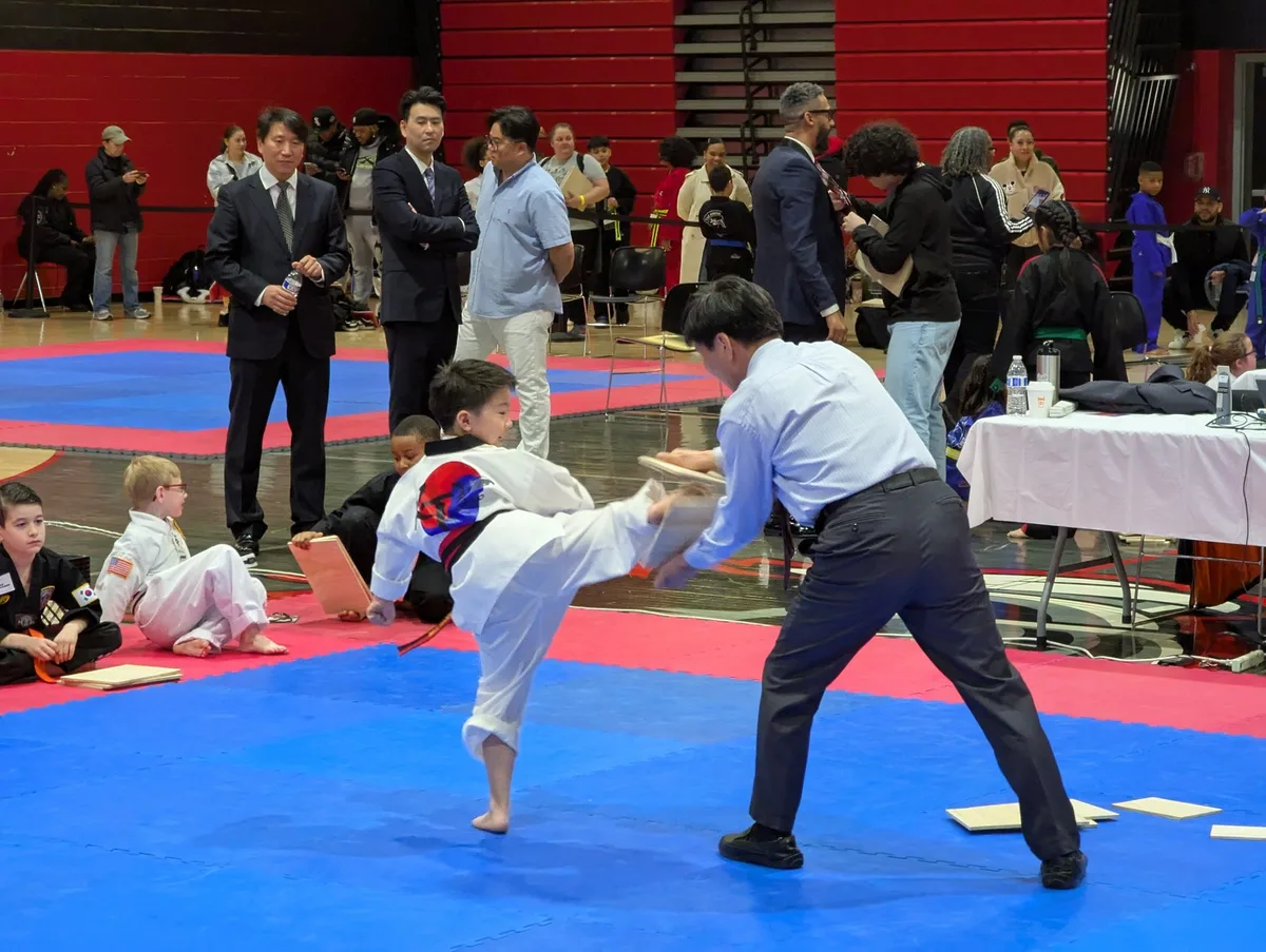 A KT Taekwondo student practicing a board-breaking kick